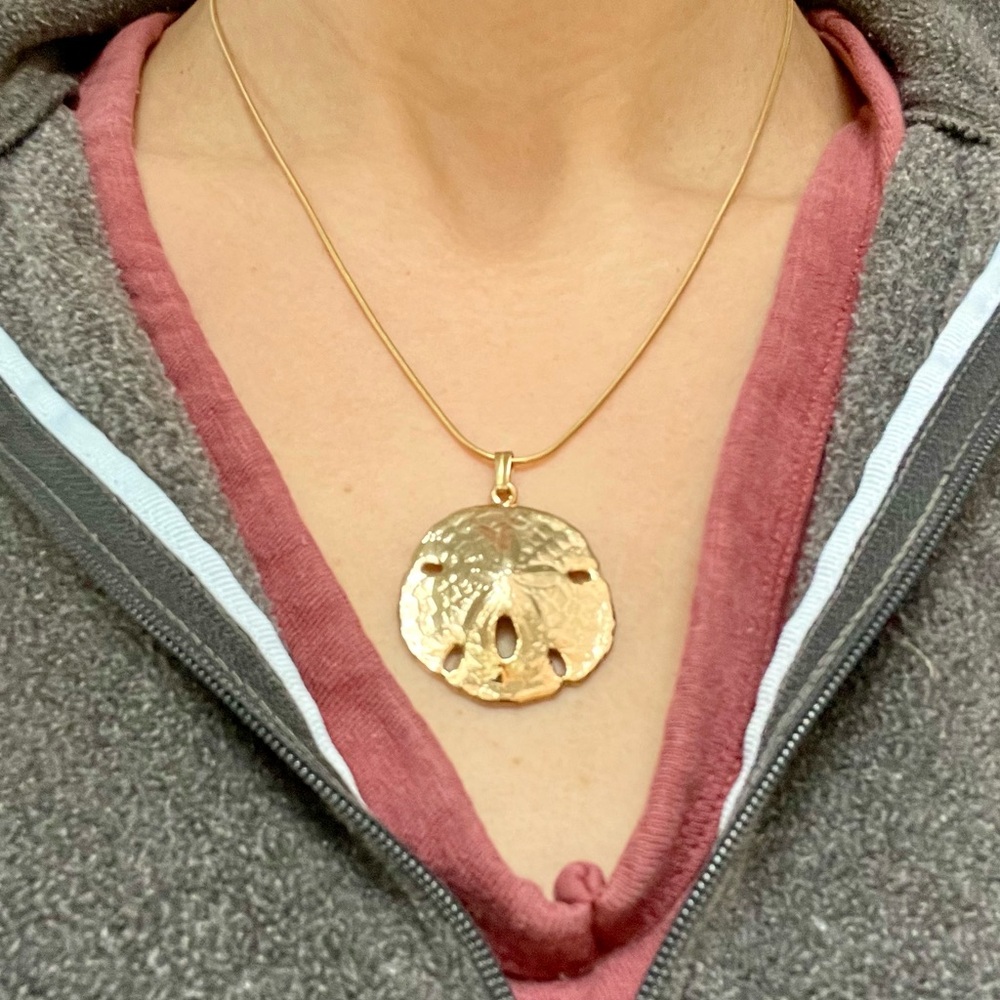 Gold colored sand dollar pendant